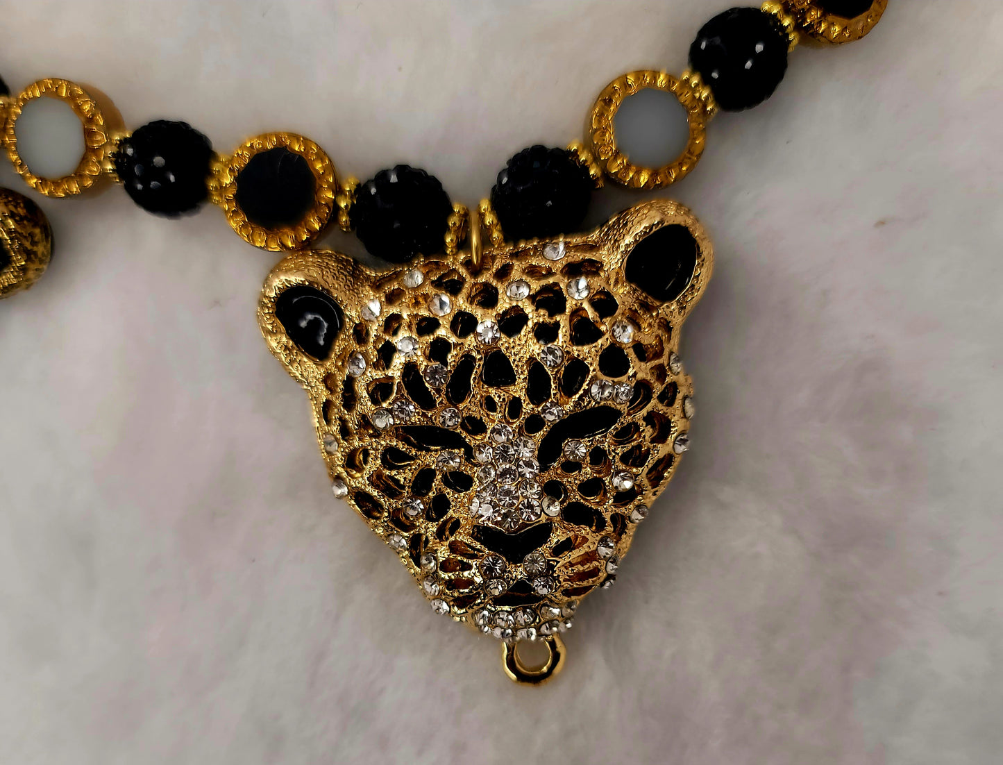 Tri-pendant leopard heads necklace with stainless-steel clasp.