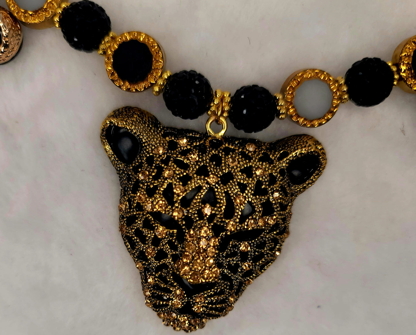 Tri-pendant leopard heads necklace with stainless-steel clasp.