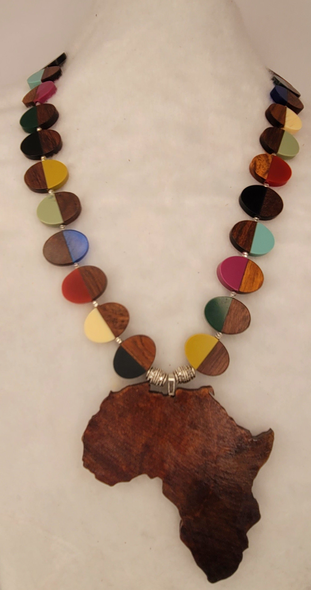 Large wood African Pendant with multi-colored wood and resin necklace with silver tone accent beads.