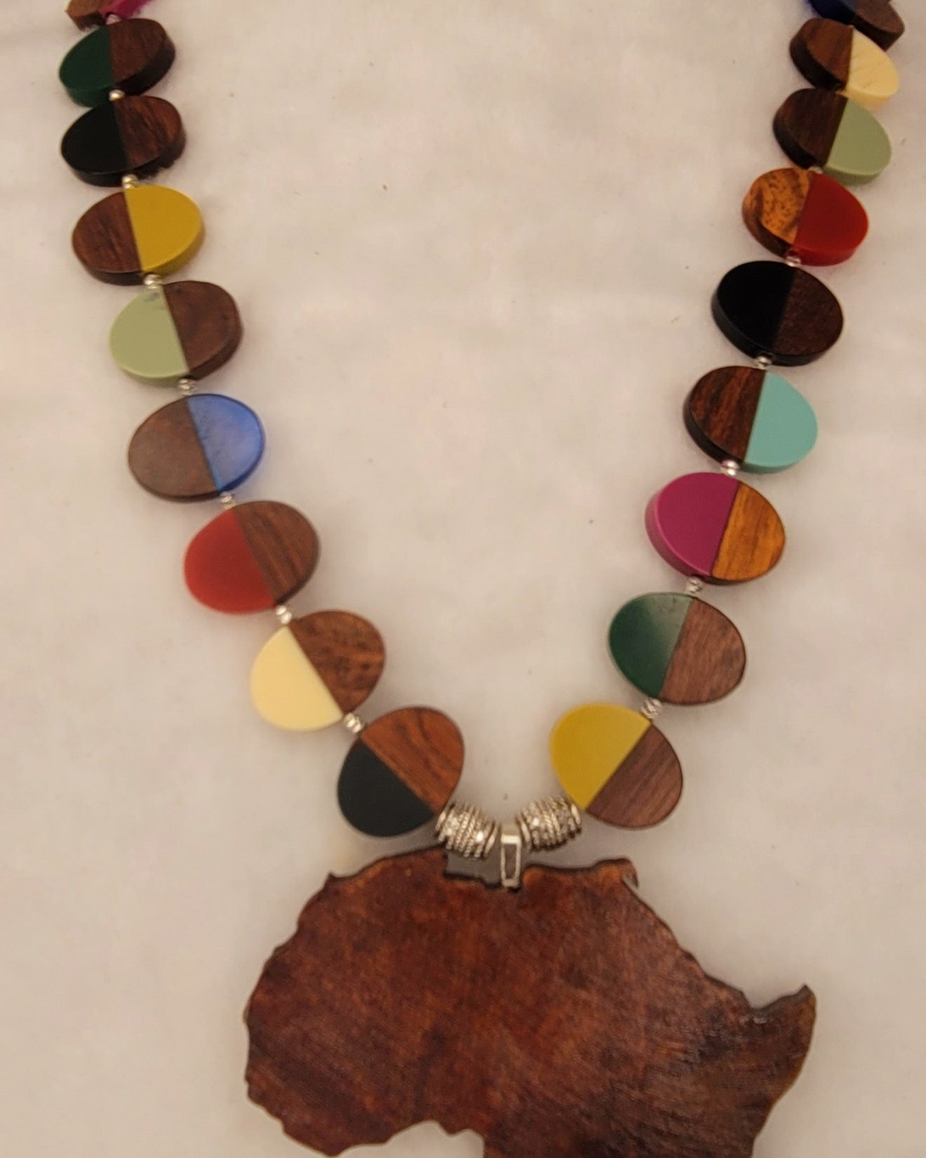 Large wood African Pendant with multi-colored wood and resin necklace with silver tone accent beads.