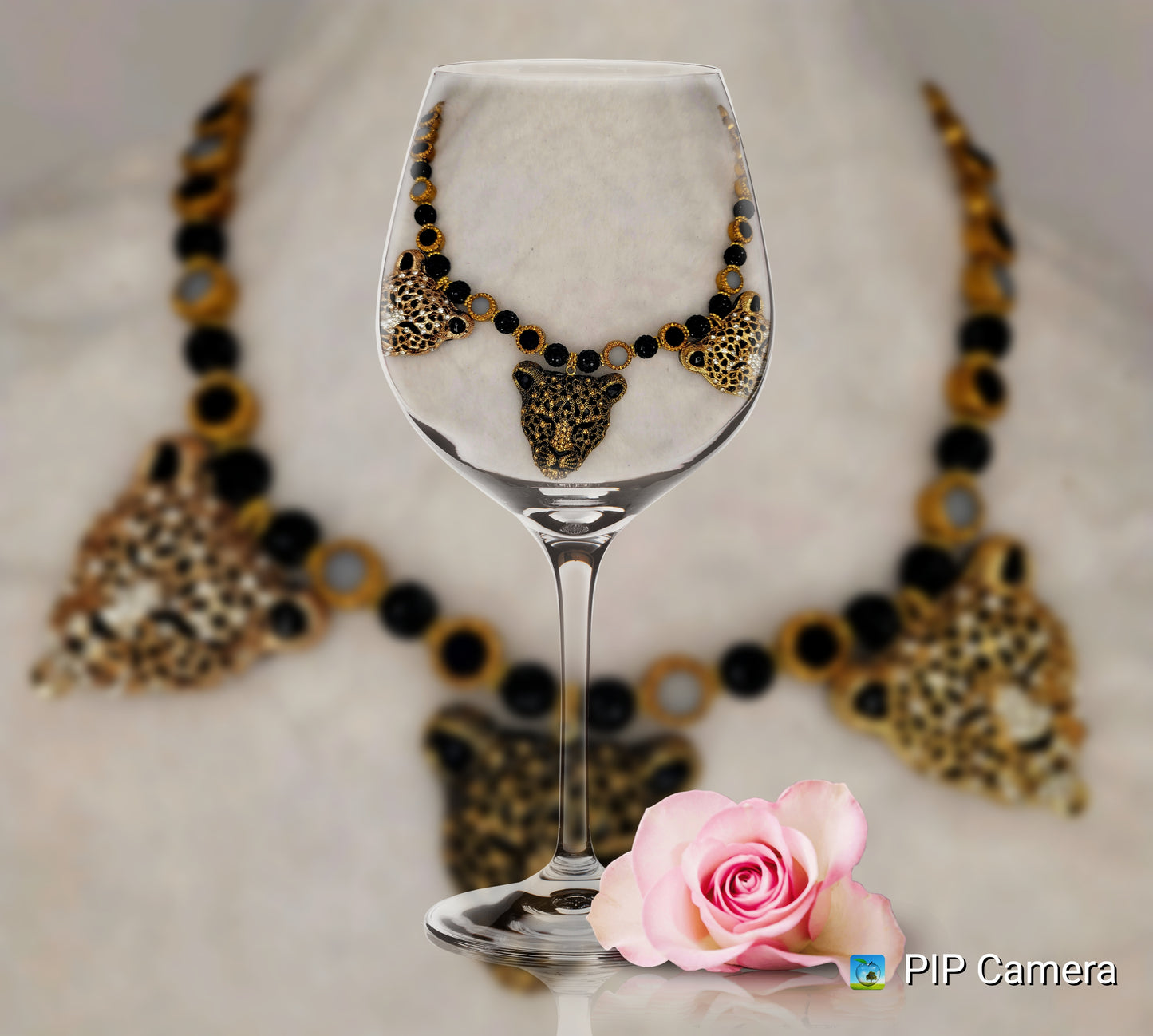 Tri-pendant leopard heads necklace with stainless-steel clasp.